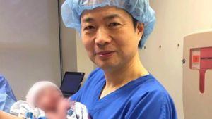El doctor John Zhang junto al bebé concebido gracias a la nueva técnica que incorpora el ADN de tres personas.